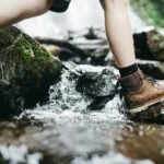 person stepping on rock