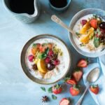 two bowls of oatmeal with fruits